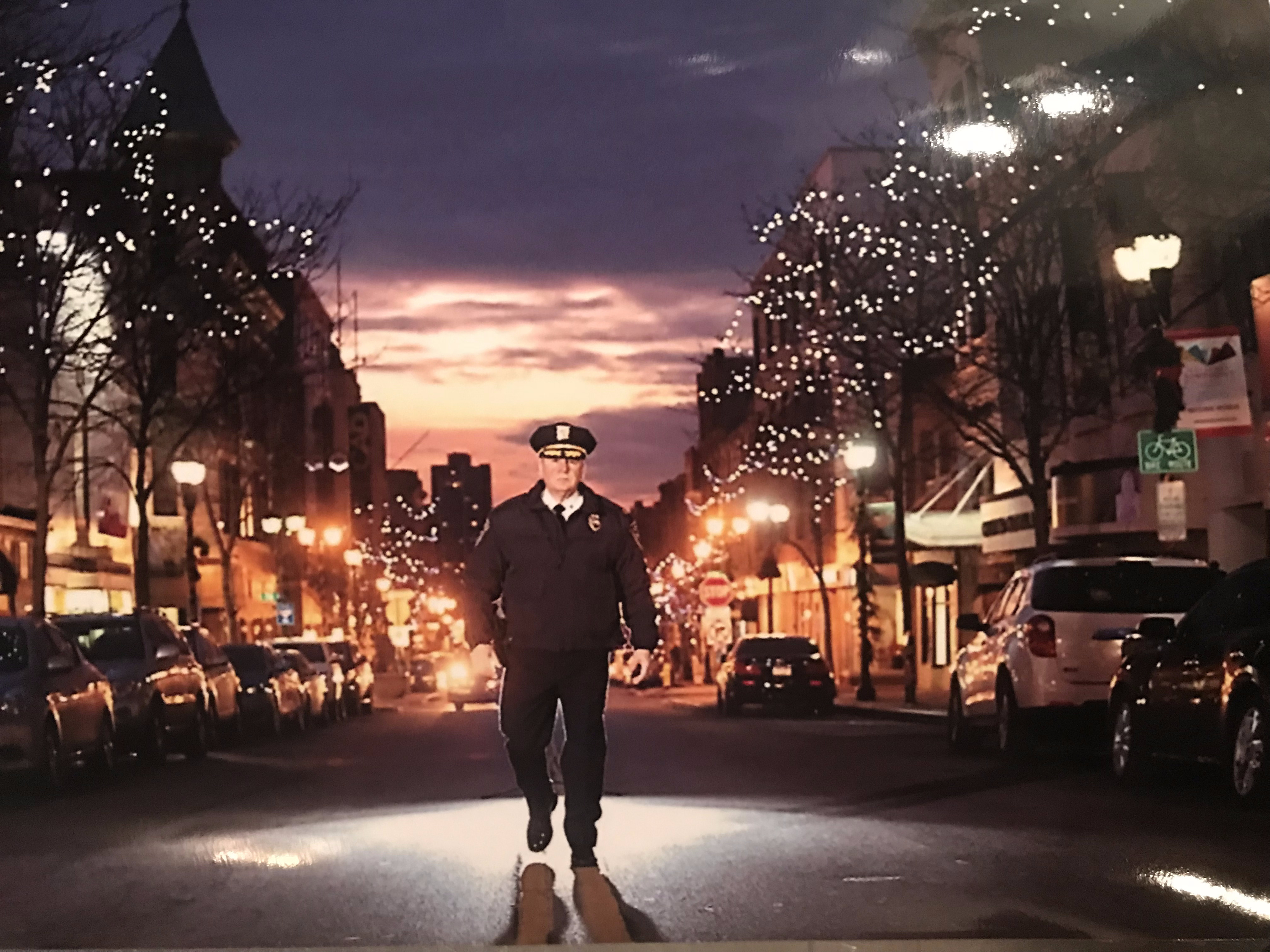 Chief Tracy walking city streets at sunset